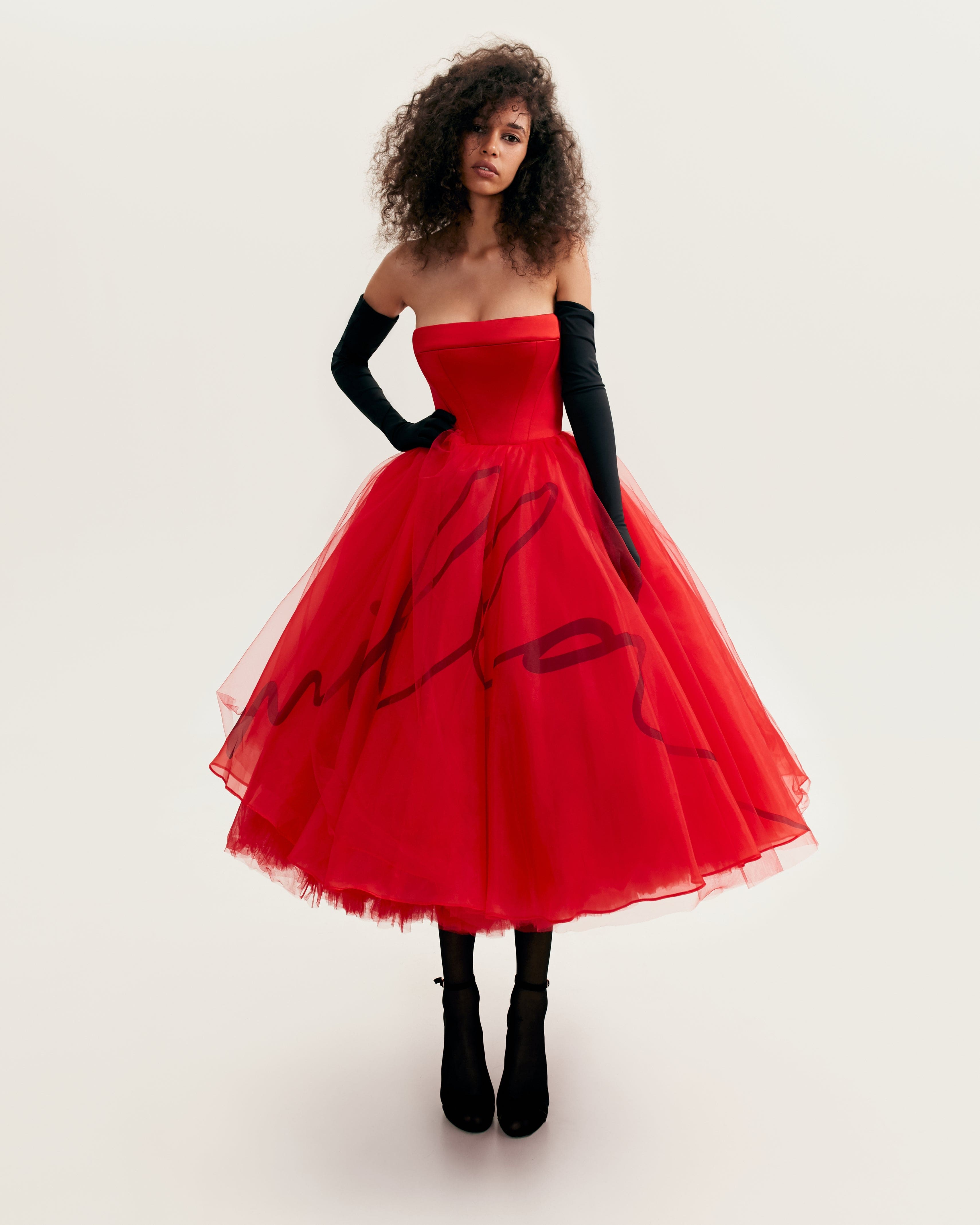 Dramatic red organza dress adorned with Milla's signature and black gloves, Xo Xo