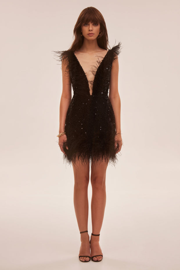 Dramatic cocktail dress on straps decorated with sequins and feathers